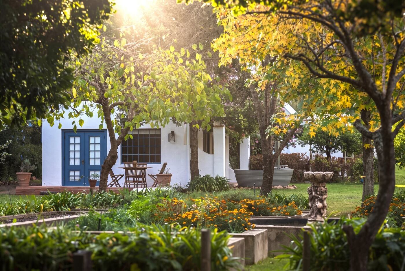The cottage through the autumn garden, blue doors open
