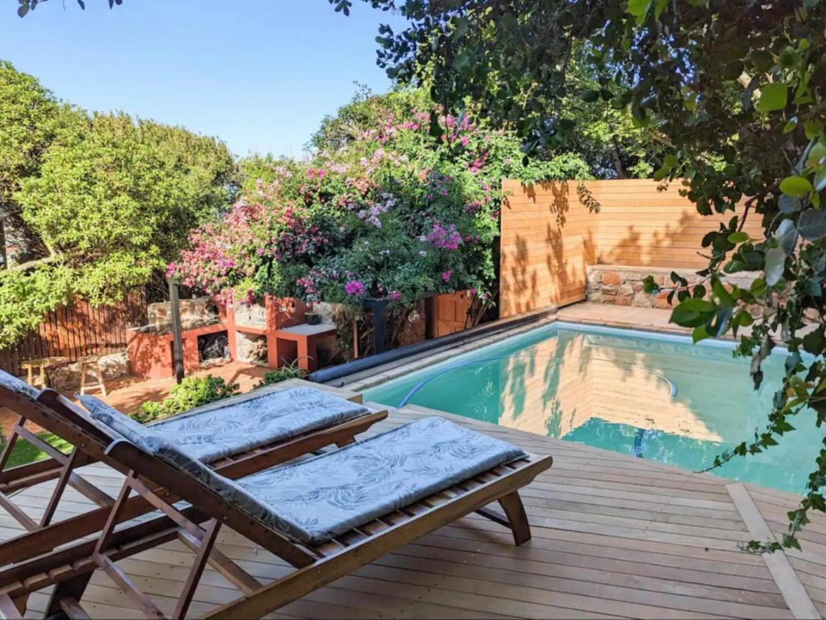 The Mountainside Home pool: loungers on the deck under the bougainvillea